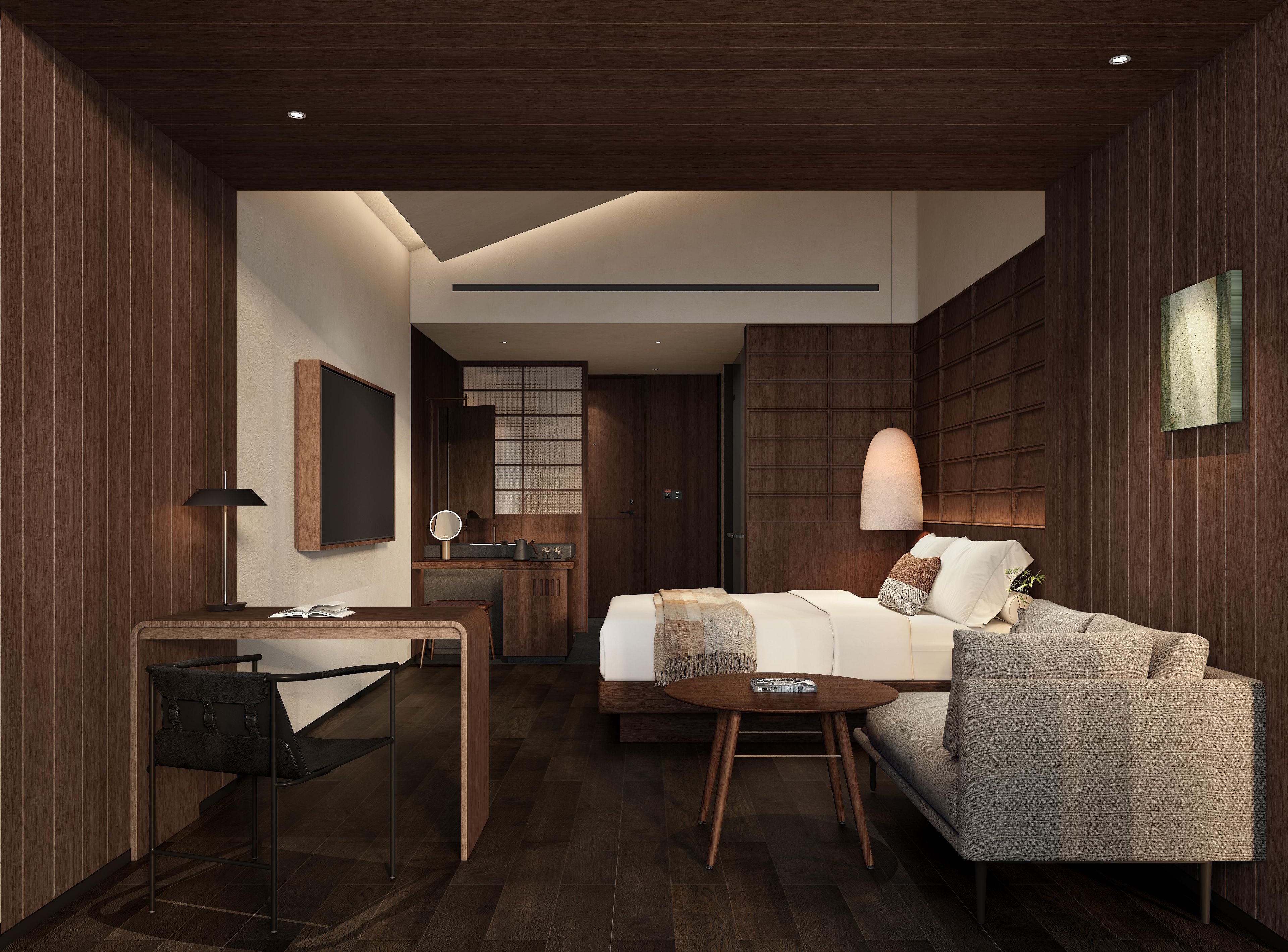 A modern hotel room with a bed, a desk, a chair, a round table, and a mirror.