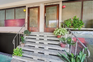 A staircase leading to a door with a sign indicating a public restroom. - OYO Collection O Ratan Lal Nagar (Kanpur)
