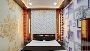 A hotel room with a large bed, a wooden headboard, a nightstand with a lamp, and decorative wall panels. - Hotel O Gurdev Metro Station Kanpur (Kanpur)