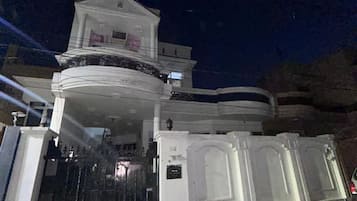 A multi-story building with a prominent entrance and a balcony.
