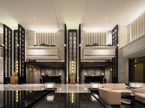 A modern hotel lobby with a reception desk, seating area, and a high ceiling with skylights. - LIUYANG DOLTON INTERNATIONAL HOTEL (Changsha)