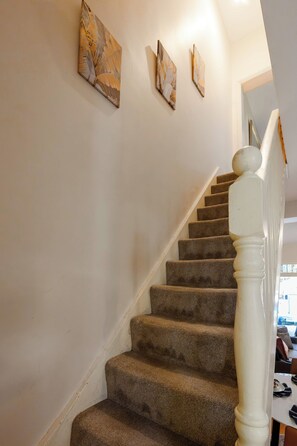 A staircase with carpeted steps and a white balustrade. - Charming 2BD Near ICC, Casino and Darling Harbour (Pyrmont)