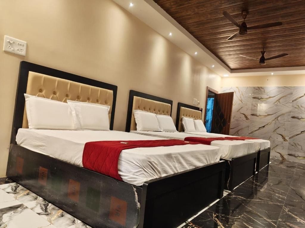 A hotel room with a large bed, a ceiling fan, and marble flooring.