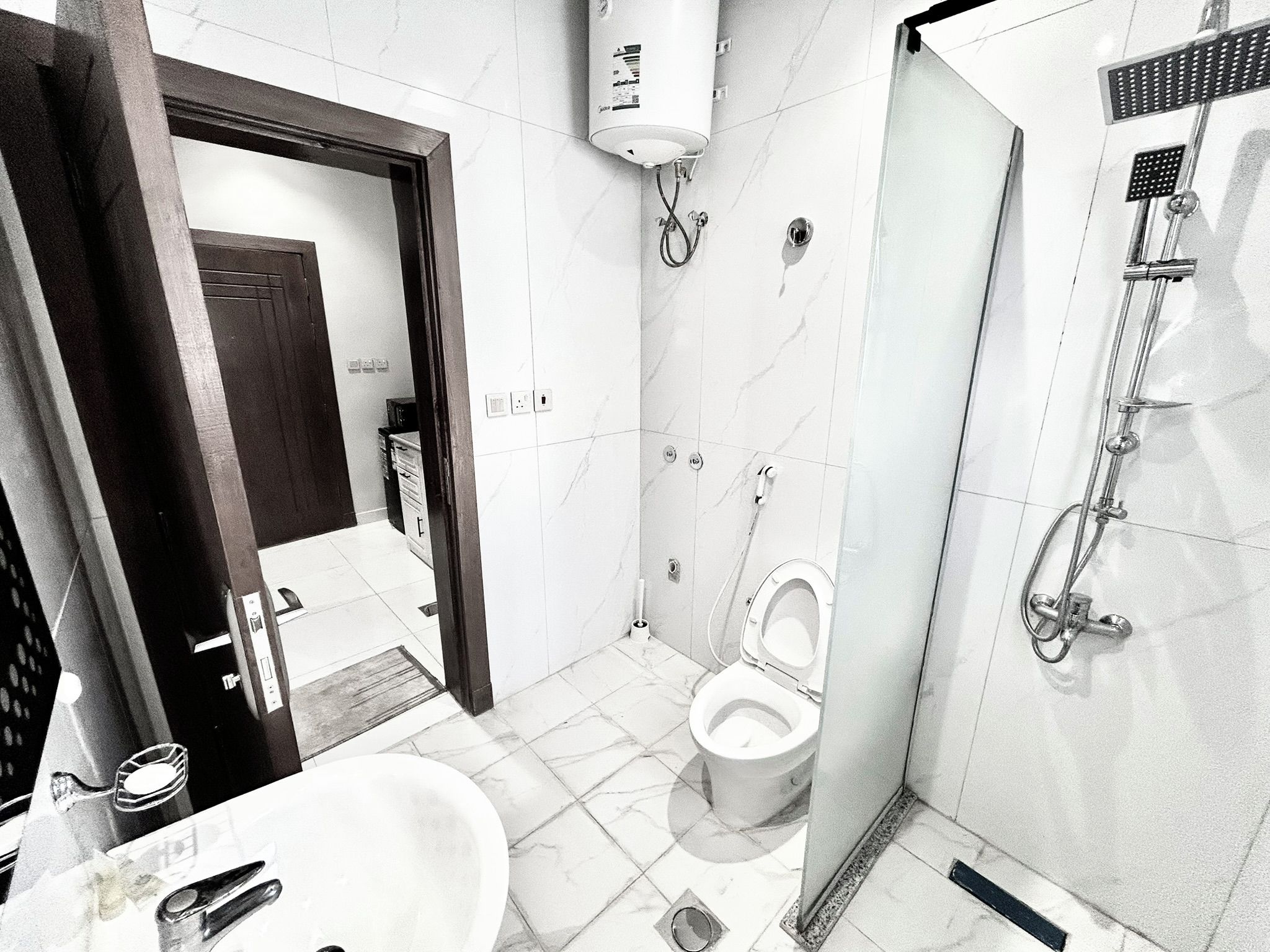 A modern bathroom with a toilet, bidet, and shower.