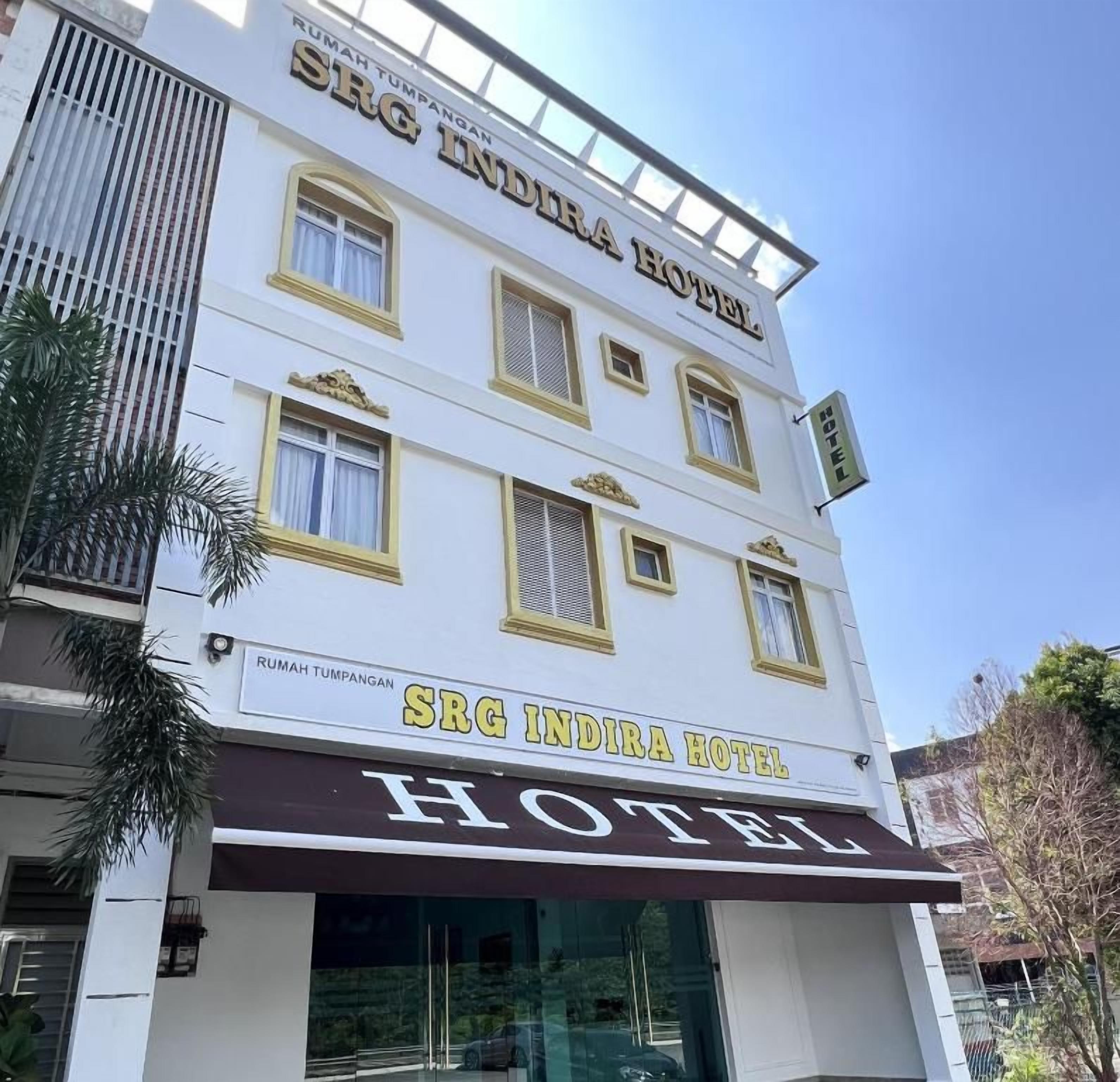 A hotel building with a sign reading 'SRG INDIRA HOTEL.'