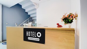 A hotel reception desk with a sign indicating it's company-serviced. - OYO Hotel O Gomti Nagar Near Amity (Lucknow)