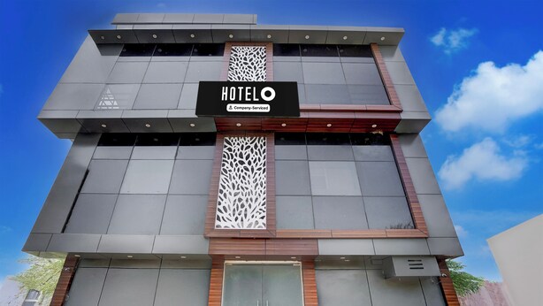 A modern hotel building with a prominent sign reading 'HOTEL' and 'Company-Serviced'. - OYO Hotel O Gomti Nagar Near Amity (Lucknow)