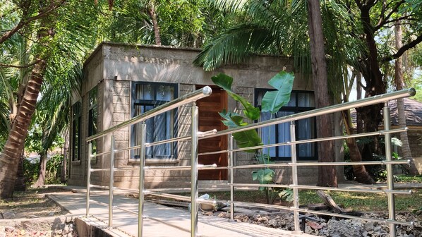 A concrete building with a metal staircase and a window.
