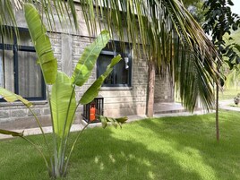 A building with a stone facade, large windows, and a well-maintained lawn.