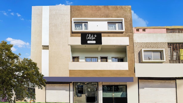 A modern building with a flat facade, a sign indicating it is company-serviced, and a gated entrance. - Collection O Ujjain City Centre (Ujjain)