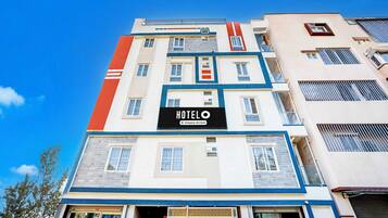 A multi-story hotel building with a prominent 'HOTEL' sign on the facade.