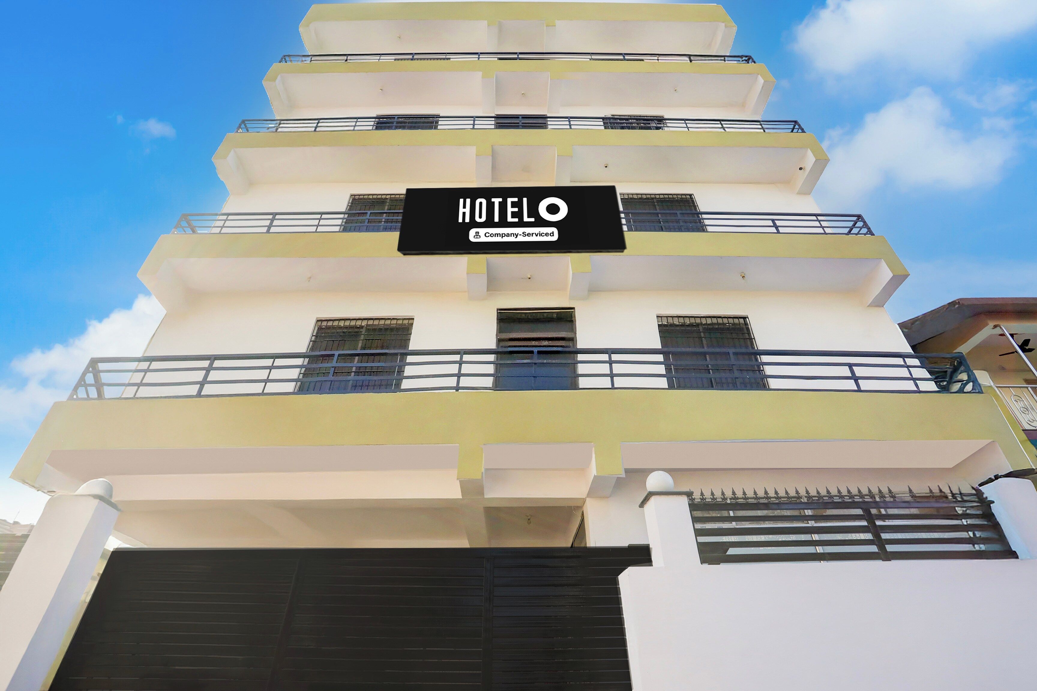 Un edificio de hotel de varios pisos con un letrero que indica que es un servicio de empresa.