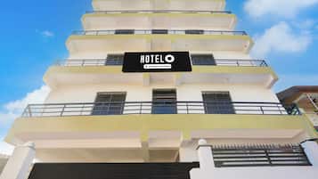 Un edificio de hotel de varios pisos con un letrero que indica que es un servicio de empresa.