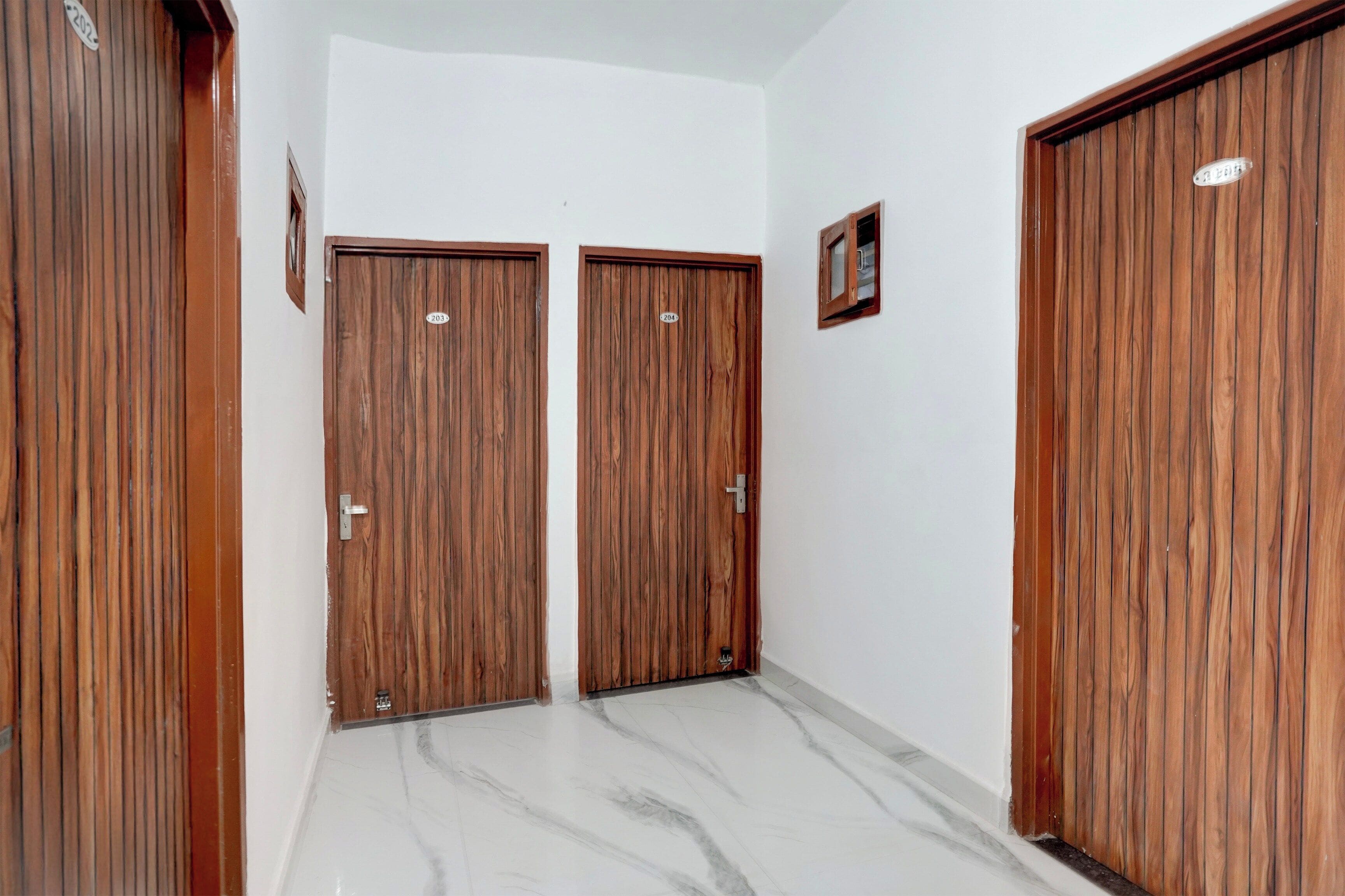 A hallway with two wooden doors, each marked with a number.