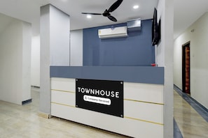 A reception desk with a sign indicating it is a company-serviced area. - Townhouse Nagole RTO Office (Hyderabad)