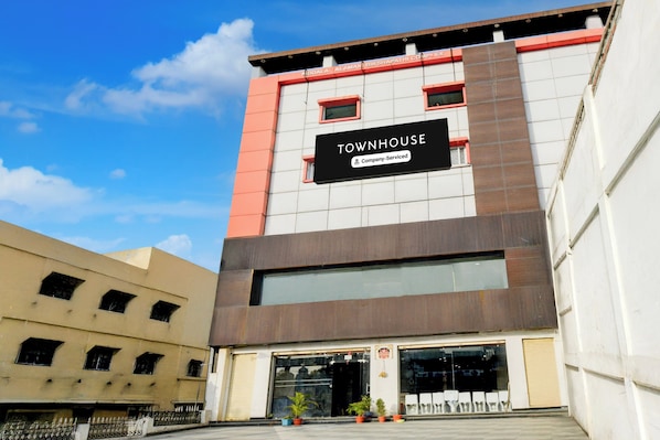 A modern building with a sign reading 'TOWNHOUSE Company Serviced'. - Townhouse Nagole RTO Office (Hyderabad)