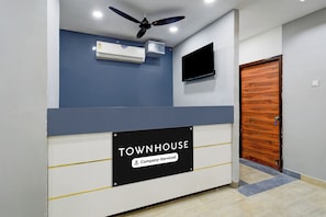 A reception area with a sign that reads 'TOWNHOUSE Company-Serviced.'