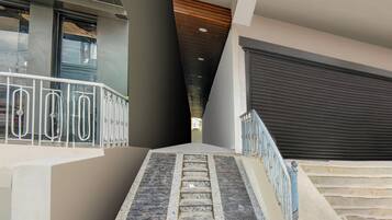 A staircase with metal railings leading to a building entrance.