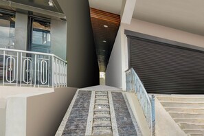 A staircase with metal railings leading to a building entrance.
