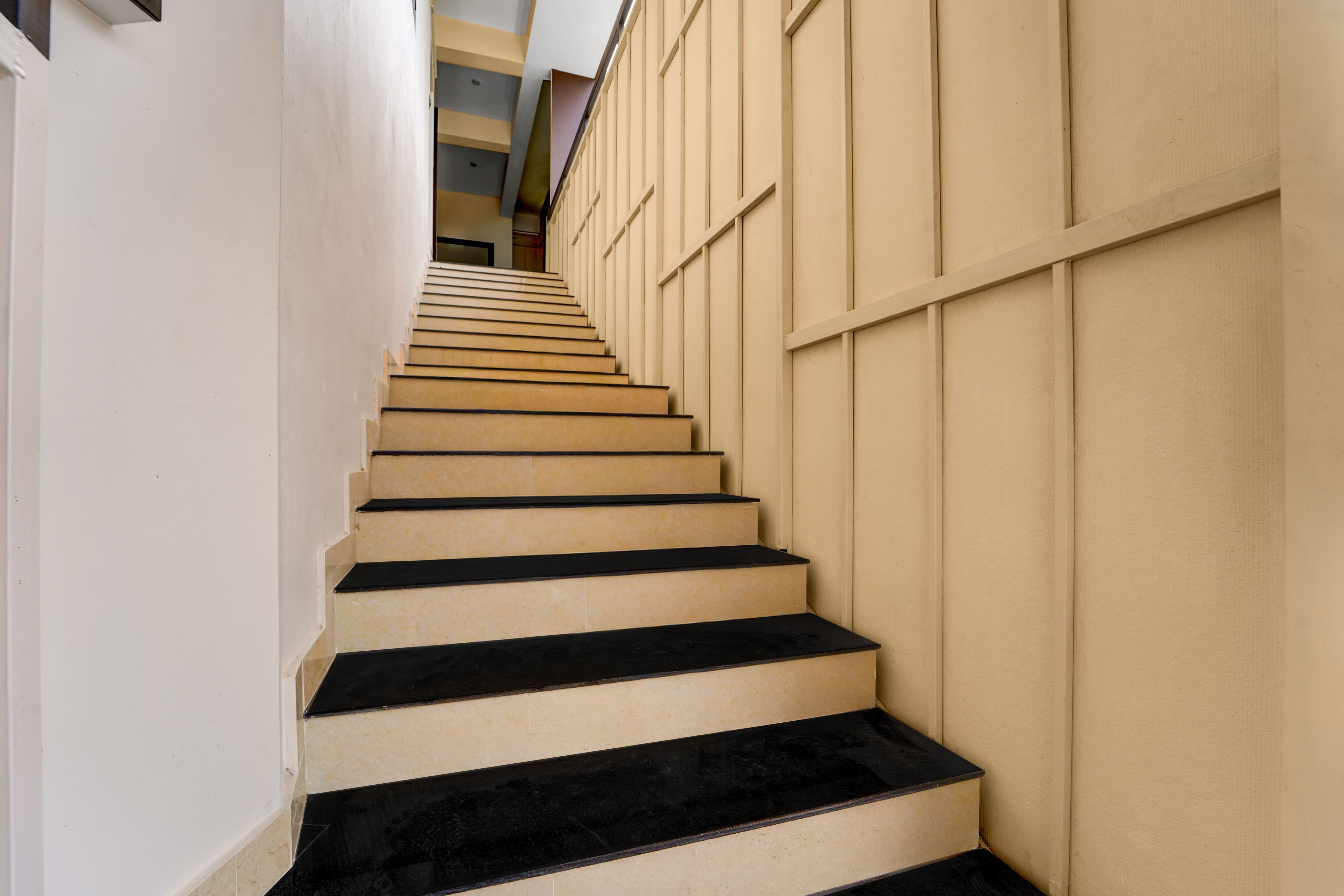A staircase with alternating beige and black steps leading upwards.