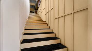 A staircase with alternating beige and black steps leading upwards.