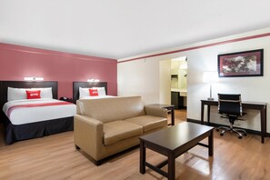 A hotel room with two beds, a sofa, a desk, and a chair. - King Bed Non Smoking (Tulsa)