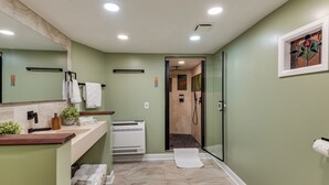 A bathroom with a shower, a sink with a mirror, and a towel rack. - Hot Tub & 2 Fire Pits! Secluded Lyles Getaway (Lyles)