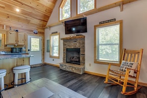 A cozy interior with a stone fireplace, wooden ceiling, and a television mounted above it. - 4 Mi to Cherokee Lake! Wooded Escape Near Hiking (Murphy)