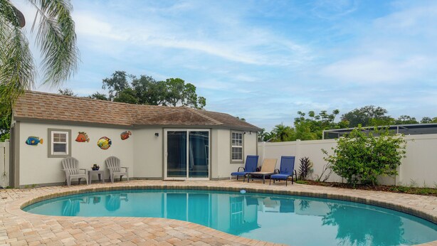 A residential property with a swimming pool, patio furniture, and a tiled deck. - Hot Tub, Water View! Largo Home 10 Mi to Beaches (Largo)