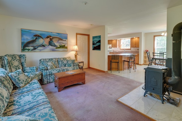 A living room with patterned sofas, a coffee table, and artwork on the walls. - 21 Acres, Near Trails to Shore with Island Access (Lubec)