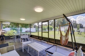 A covered outdoor seating area with a hammock, chairs, and a table. - Families w/ Pets Welcome! Retreat 14 Mi to Tampa (Brandon)