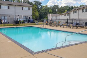 A swimming pool with a black metal fence, lounge chairs, and a lifebuoy. - Relax at Oxford Retreat! Experience Ole Miss (Oxford)