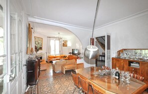 A spacious living area with a dining table, sofas, and a staircase leading to another level. - Stunning home in Espira-de-l'Agly (Espira-de-l'Agly)