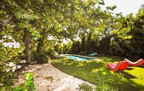 A backyard with a swimming pool, a slide, and a seating area with chairs and a table. - Stunning home in Espira-de-l'Agly (Espira-de-l'Agly)