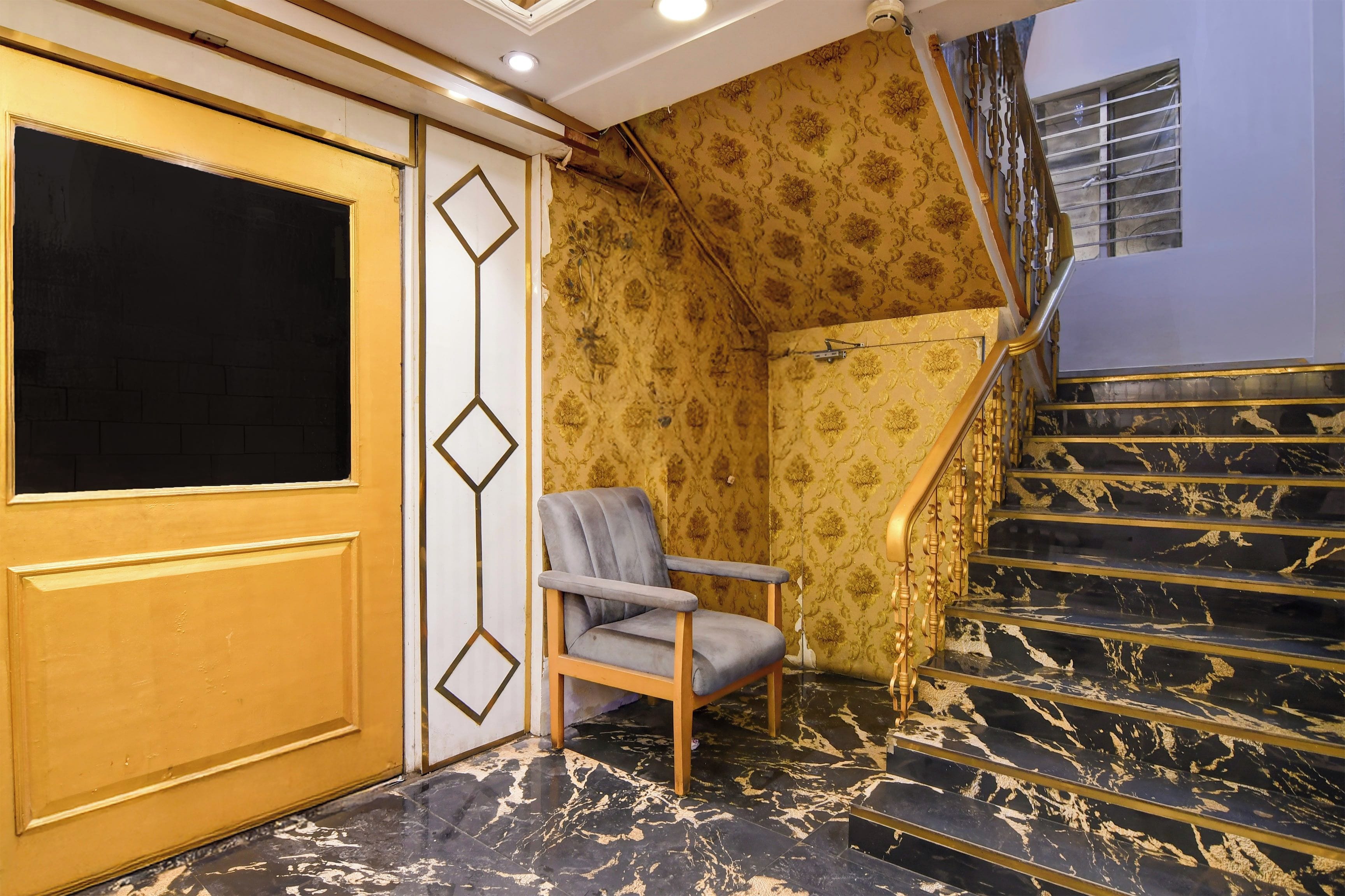 A room with a marble staircase, a chair, and a door with a geometric design.