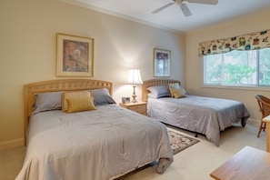A bedroom with two beds, a nightstand with a lamp, a chair, and a window with blinds. - 1 Mi to Beach! Golfer’s Paradise on Pawleys Island (Pawleys Island)