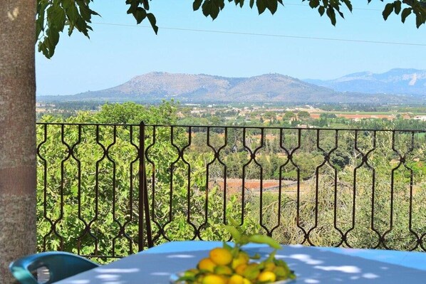 A balcony with a view of a mountainous landscape.