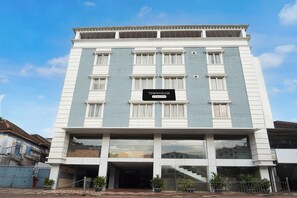 A multi-story building with a sign indicating it is a company-serviced townhouse.