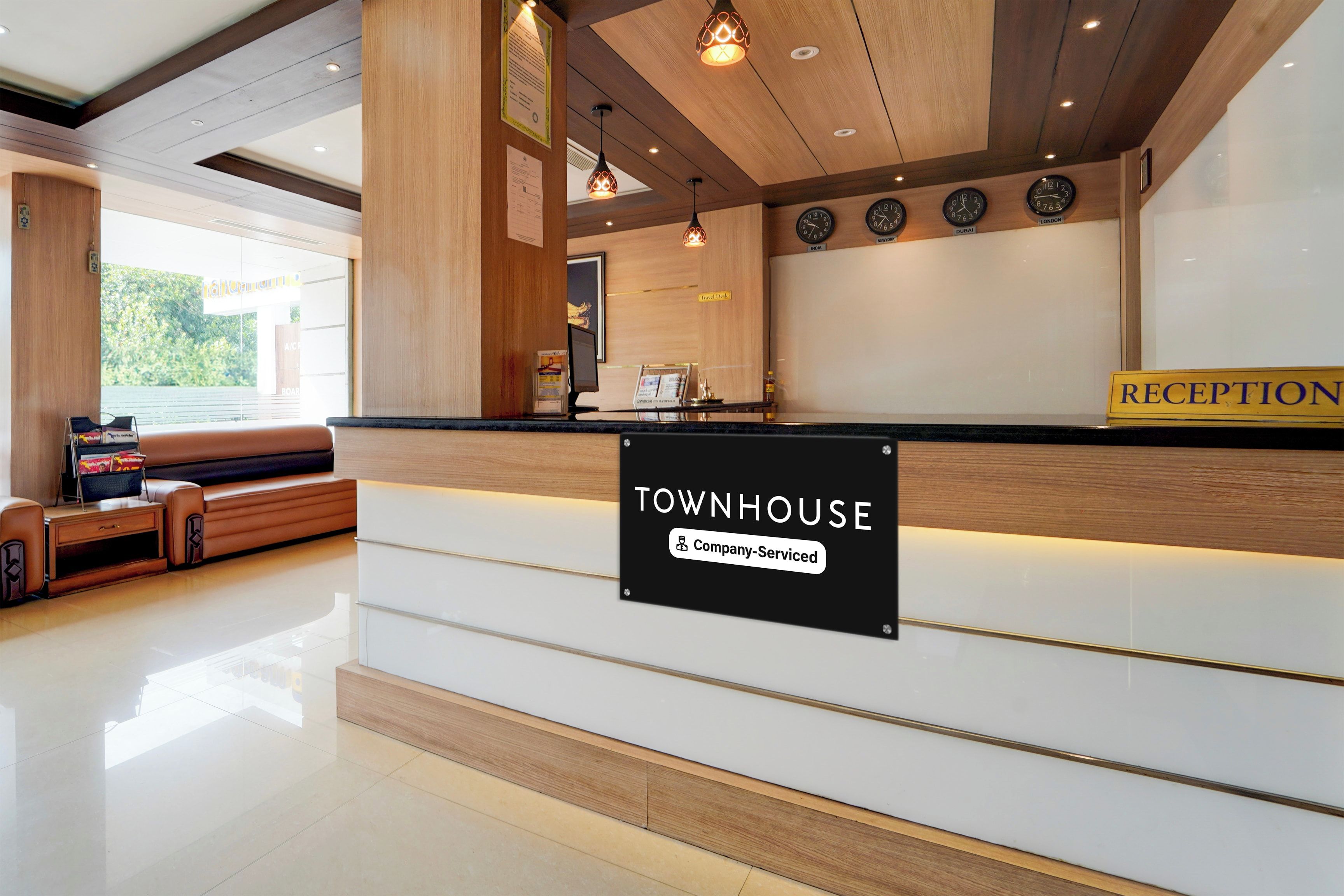 A reception area with a sign reading 'Townhouse Company Serviced'.