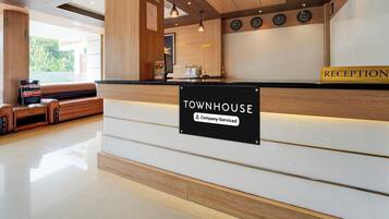 A reception area with a sign reading 'Townhouse Company Serviced'.