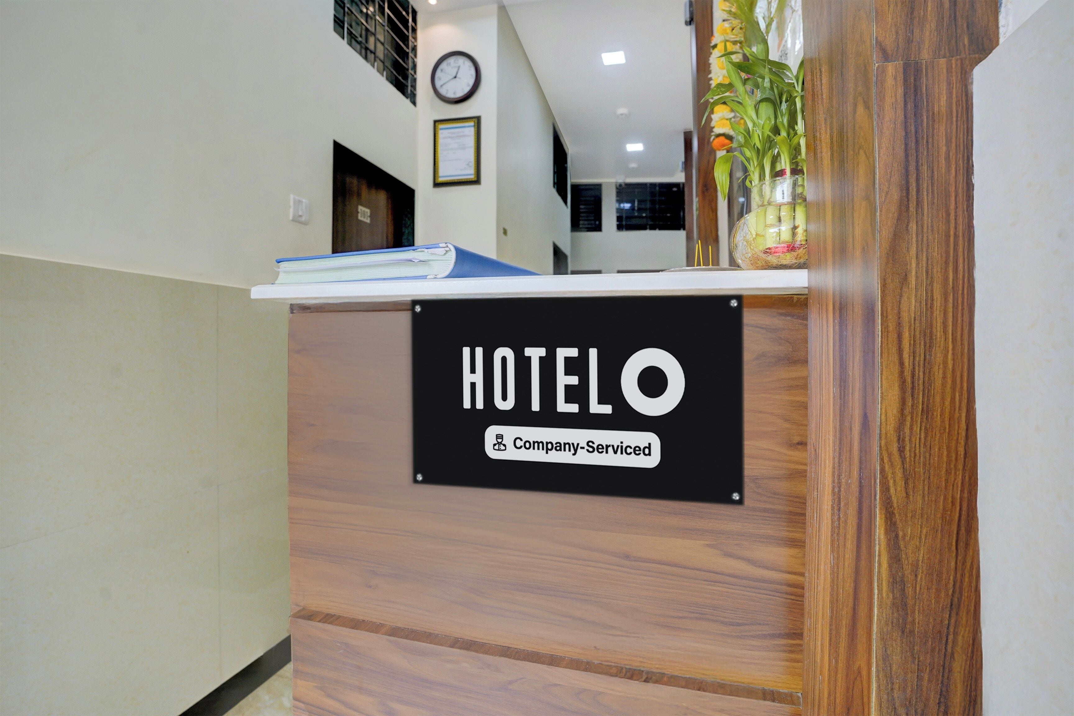 A reception desk with a sign that reads 'HOTEL O' and 'Company Serviced.'