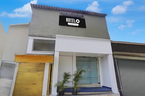 A hotel named 'HOTEL' with a company-serviced sign, a modern facade, and a clear sky. - Hotel O Jagruti Nagar Ghatkopar (Mumbai)
