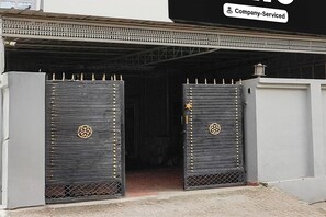 A gated entrance with decorative metal grilles and a company-serviced sign above. - Super Hotel O Dehradun City Centre (Dehradun)