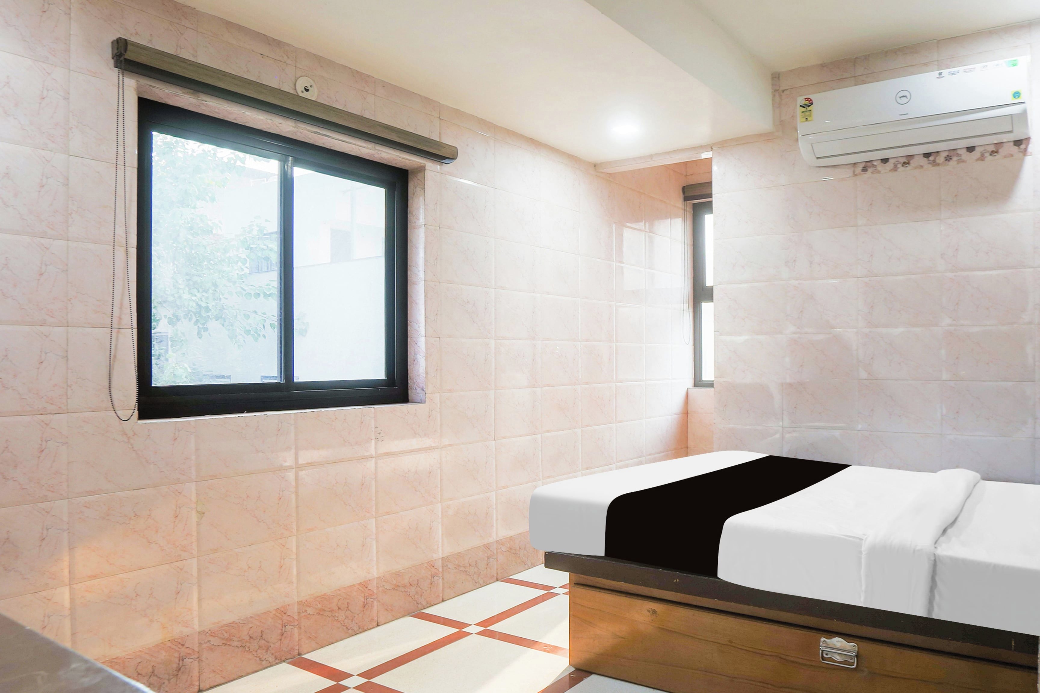 Un baño con ventana, ducha y cama.