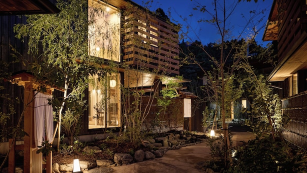 A traditional Japanese-style building with a garden pathway leading to the entrance. - tuuli YUFU Kinrinko (Yufu)
