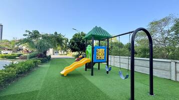 A playground with a slide and climbing structures.