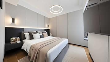 A modern bedroom with a large bed, bedside tables, a built-in wardrobe, and a circular ceiling light.
