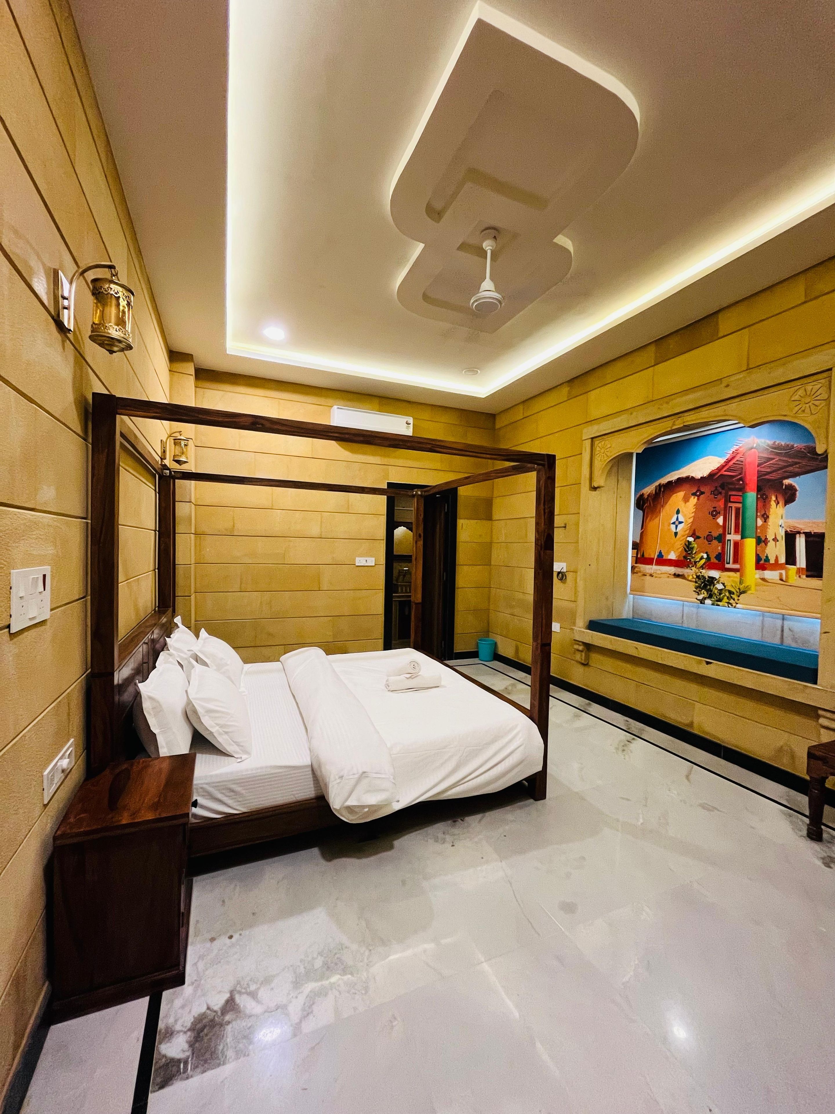A hotel room with a four-poster bed, a large mirror, and a mural on the wall.
