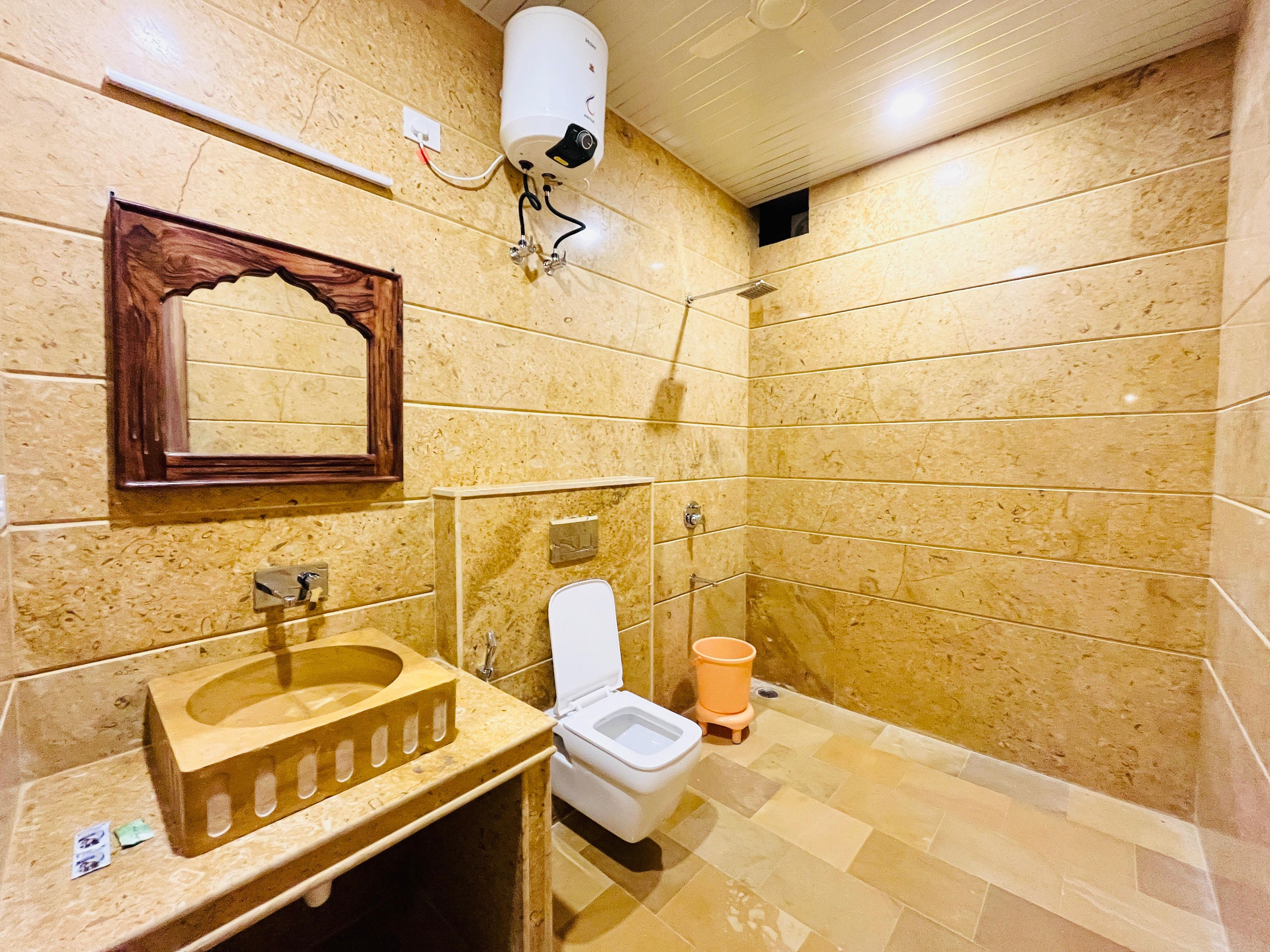 A bathroom with a wooden sink, a toilet, and a shower.
