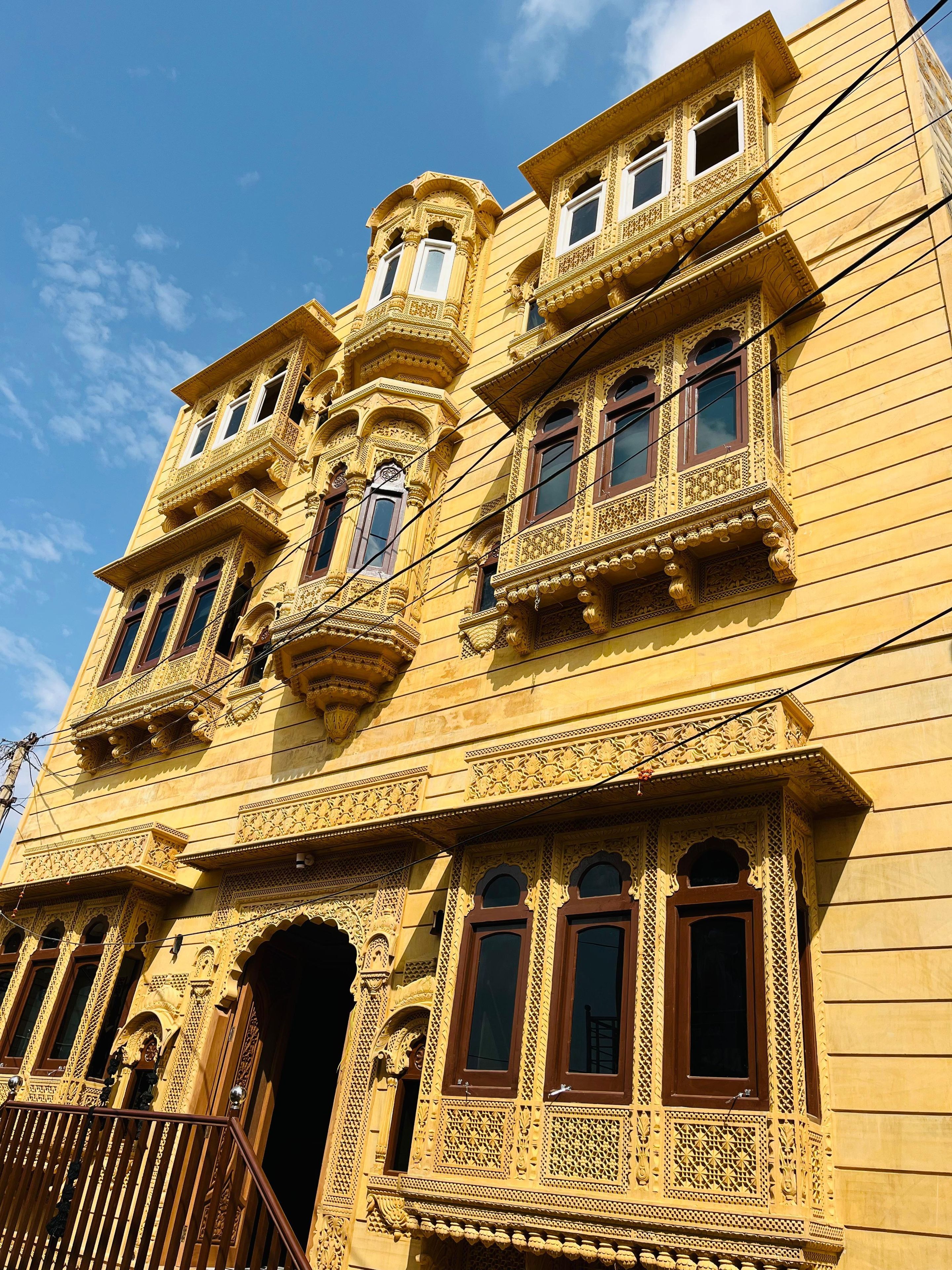 A multi-story building with ornate architectural details, including carved balconies and windows.